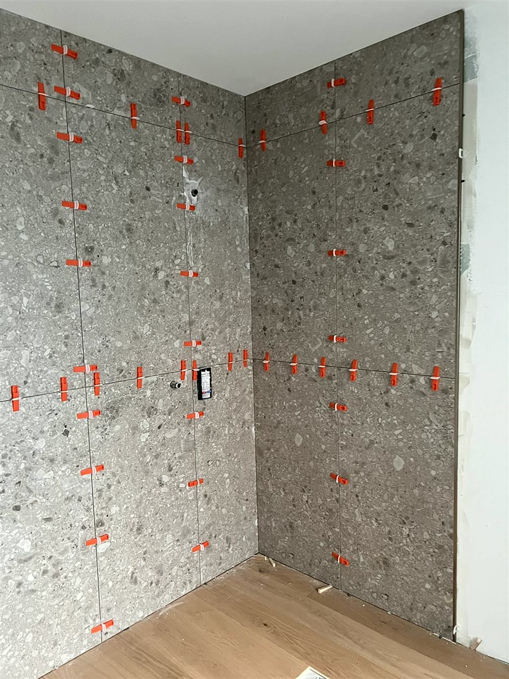 Ristrutturazione bagno: rivestimento a piastrelle in fase di posa
